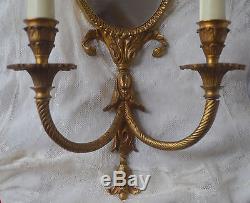 An antique French heavy bronze mirrored wall sconce, ribbon decoration